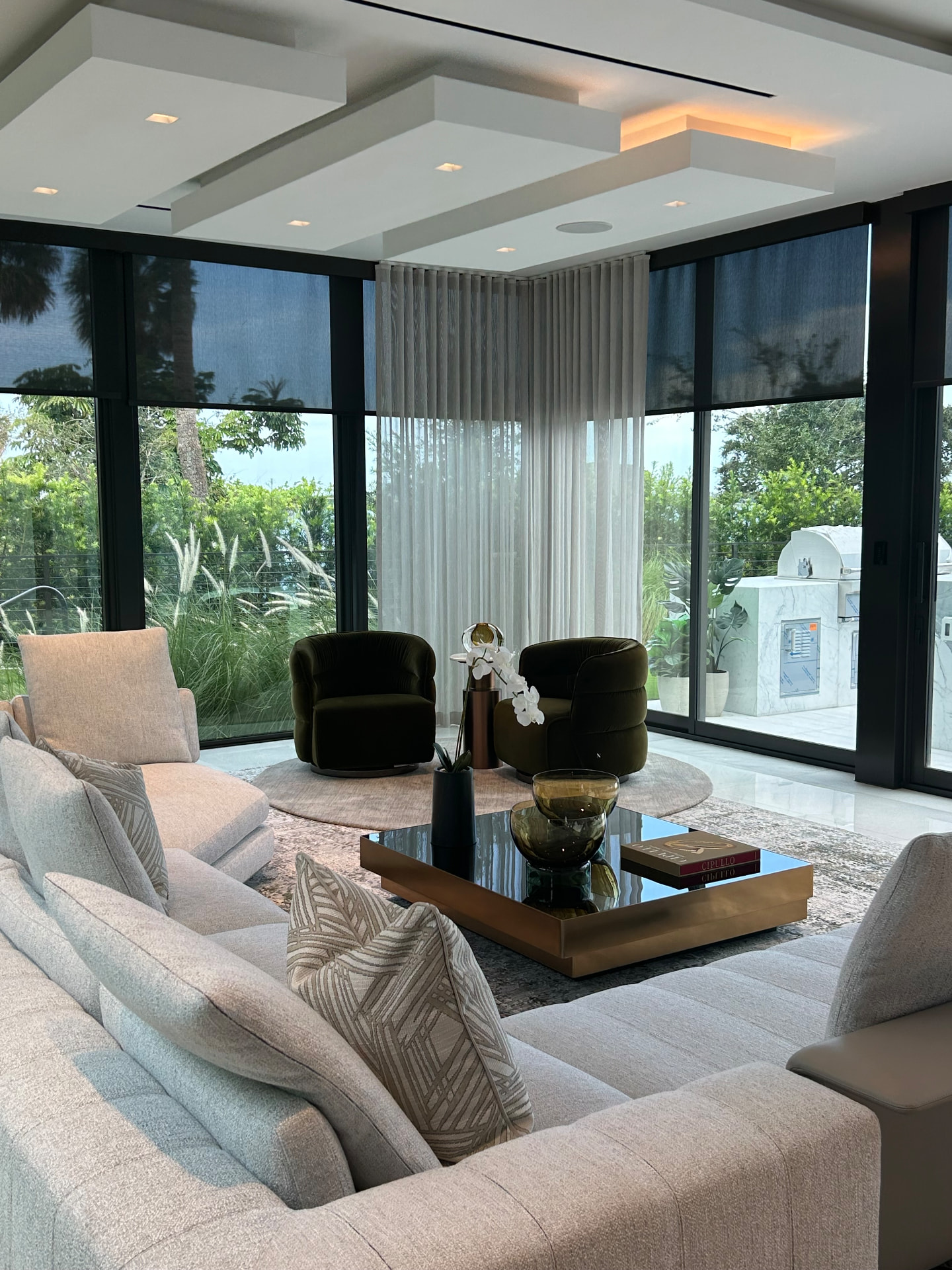 Waterfront estate great room with sheer drapery and solar shades